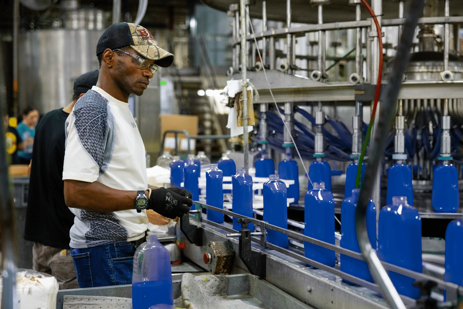 man watching a manufacturing fill line